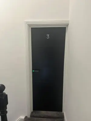 a black elevator door in a white room at Flat3 large modern king Bed flat private bathroom ryan's place in Walton on the Hill