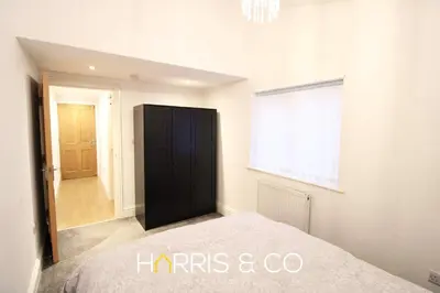 a bedroom with a black cabinet and a window at Fishermans Rest in Fleetwood