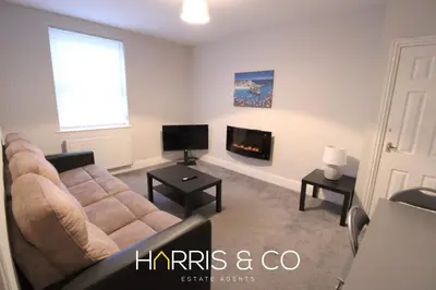 a living room with a couch and a tv at Fishermans View in Fleetwood