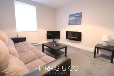 a living room with a couch and a tv at Fishermans View in Fleetwood