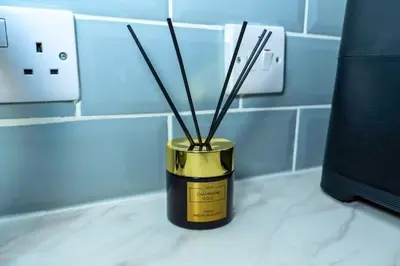 a gold and black container with sticks in it on a counter at Sleek Apartment in Blackpool, Beach View, WiFi, Sleeps 6 in Blackpool