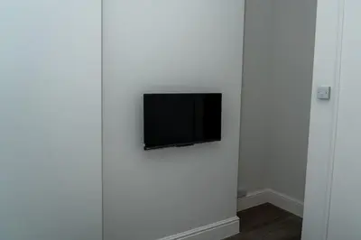 a flat screen tv on a wall in a room at Sleek Apartment in Blackpool, Beach View, WiFi, Sleeps 6 in Blackpool