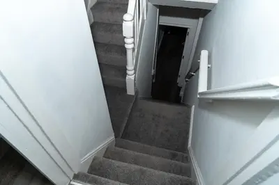 a stairway with stairs leading up to a door at Sleek Apartment in Blackpool, Beach View, WiFi, Sleeps 6 in Blackpool
