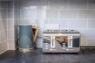 a toaster sitting on top of a kitchen counter at Modern 3-Bed Home-Liverpool Stay in Sefton