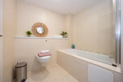 a bathroom with a toilet and a tub and a sink at Stunning Liverpool Dockside Apt by City SuperHost in Liverpool