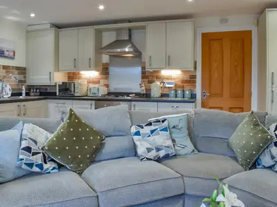 a blue couch with pillows on it in a kitchen at Sailing By in Carnforth