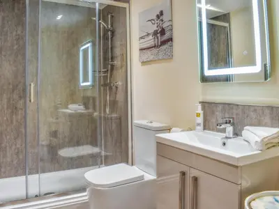 a bathroom with a shower and a toilet and a sink at Sailing By in Carnforth