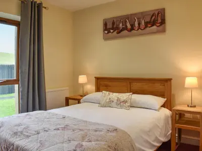a bedroom with a bed and a window at Sandpiper in Carnforth