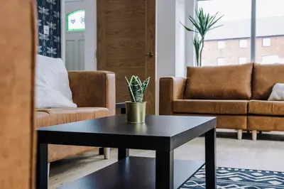 a living room with a table and a couch at Lund House in Ulverston