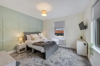 a bedroom with a bed and a window at Lund House in Ulverston