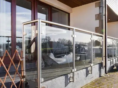 a reflection of a car in the windows of a building at Waterside Retreat in Carnforth