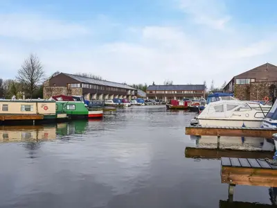 a group of boats are docked in a harbor at Waterside Retreat in Carnforth