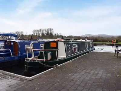 a boat is docked at a dock at Waterside Retreat in Carnforth