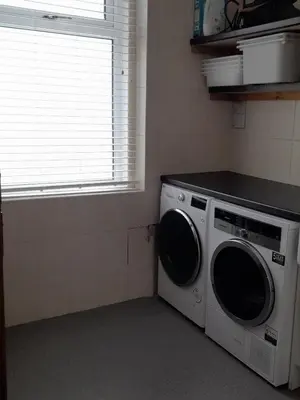 a washing machine in a kitchen with a window at Comfortable family home with amazing Seaviews in Fleetwood
