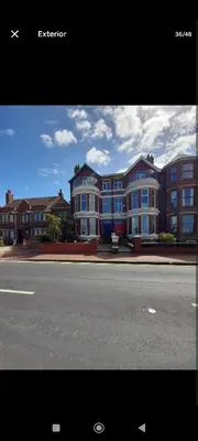 a row of houses on the side of a street at Comfortable family home with amazing Seaviews in Fleetwood