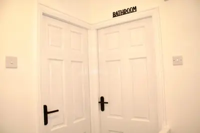 a white door with a sign on top of it at Cosy 2-Bed Home Near St Helens Centre - Free WiFi in Saint Helens