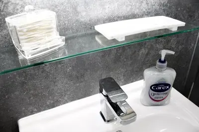 a bathroom sink with a bottle of soap on it at Cosy 2-Bed Home Near St Helens Centre - Free WiFi in Saint Helens
