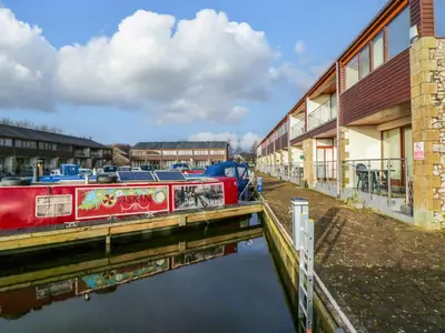 a boat is docked next to a building at 9 Swan House in Carnforth