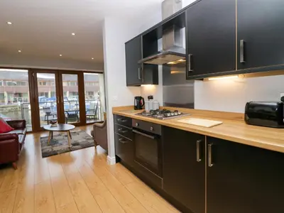 a kitchen with black cabinets and a counter top at 9 Swan House in Carnforth
