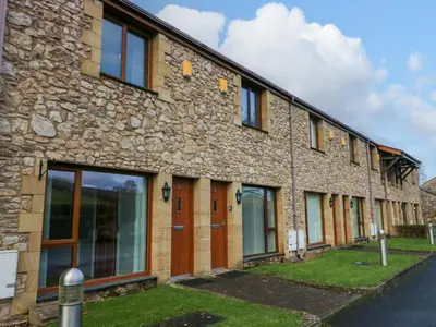 a stone building with a row of windows at 9 Swan House in Carnforth