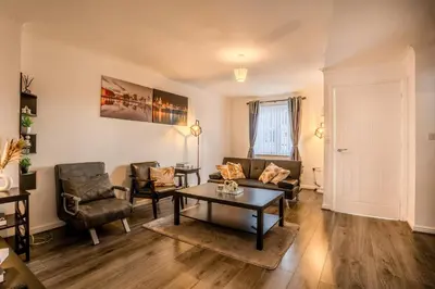 a living room with a couch and chairs and a table at 5-Beds in Quiet Three Bedroom House Near Anfield Stadium, free Parking in Liverpool
