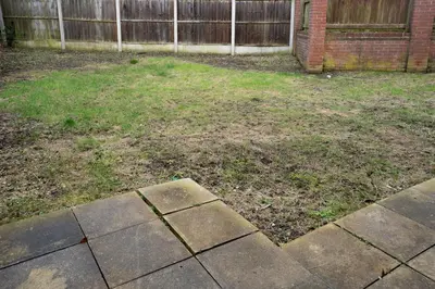 an empty yard with a fence in a backyard at 5-Beds in Quiet Three Bedroom House Near Anfield Stadium, free Parking in Liverpool