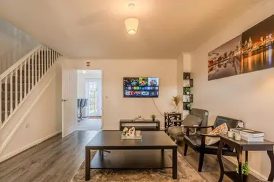 a living room with a couch and a table at 5-Beds in Quiet Three Bedroom House Near Anfield Stadium, free Parking in Liverpool