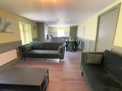 a living room with a couch and a table at Serenity Holiday Apartments in Blackpool
