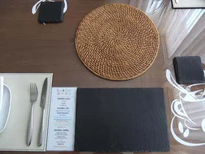 a table with utensils including a straw hat and a plate at FourRooms - Couples Only in Blackpool