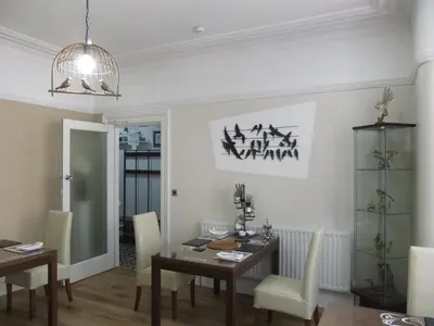 a dining room with a table and chairs at FourRooms - Couples Only in Blackpool