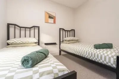 two beds sitting next to each other in a room at Charlottes Place in Liverpool