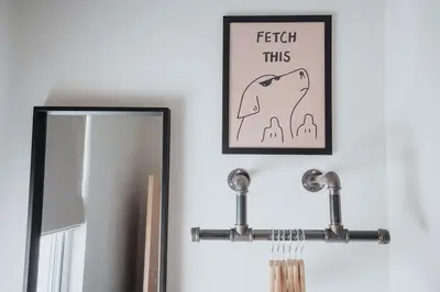 a picture of a dog on a wall next to a mirror at Charlottes Place in Liverpool