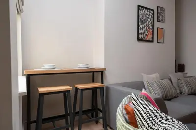 a living room with a table and a couch at Charlottes Place in Liverpool