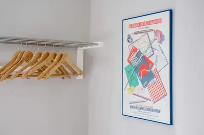 a poster on a wall next to a rack of baseball bats at Picasso's Place Liverpool Apt Sleeps 9 in Liverpool