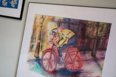a painting of a person riding a red bike at Lennon's Place Central Apartment Sleeps 5! in Liverpool
