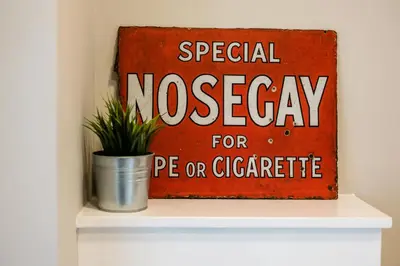 a sign on a shelf with a potted plant at Lennon's Place Central Apartment Sleeps 5! in Liverpool