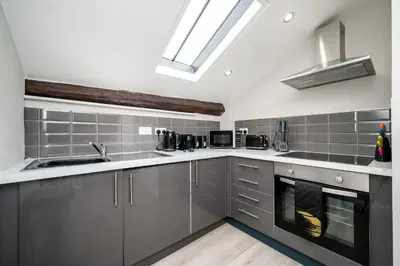 a kitchen with stainless steel appliances and a skylight at Attico, 2BR City Centre Apartment, Sleeps 6! in Liverpool