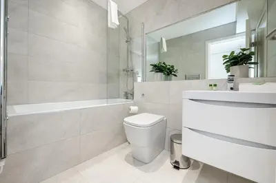 a bathroom with a toilet and a tub and a sink at Liverpool City Centre Apartment in Liverpool