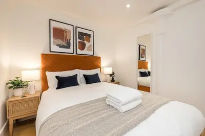 a bedroom with a large white bed with two lamps at Liverpool City Centre Apartment in Liverpool