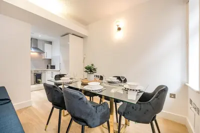 a dining room with a table and chairs at Liverpool City Centre Apartment in Liverpool