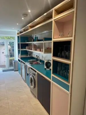 a large kitchen with a washer and dryer at Chestnut House in Southport