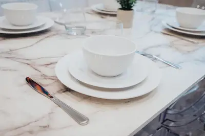 a table with white cups and saucers on a marble counter at Beautiful House - Free Parking - 5 mins to centre in Liverpool