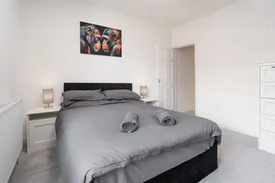 a bedroom with a bed with two pillows on it at Beautiful House - Free Parking - 5 mins to centre in Liverpool