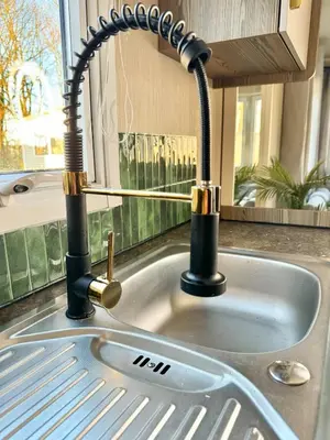 a kitchen sink with a faucet on a counter at Miarlo Lodge Derwent Haven Lakeland in Grange Over Sands