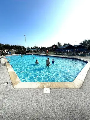a group of people in a swimming pool at Miarlo Lodge Derwent Haven Lakeland in Grange Over Sands