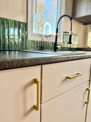 a kitchen counter with a sink and a window at Miarlo Lodge Derwent Haven Lakeland in Grange Over Sands