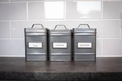 a group of four metal containers sitting on a counter at Brand-New 3-Bed Home - Liverpool in Liverpool