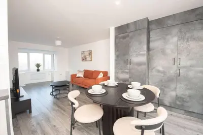 a living room with a table and chairs and a couch at Brand-New 3-Bed Home - Liverpool in Liverpool