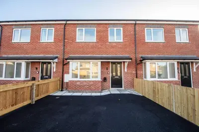 a brick building with a driveway in front of it at Brand-New 3-Bed Home - Liverpool in Liverpool
