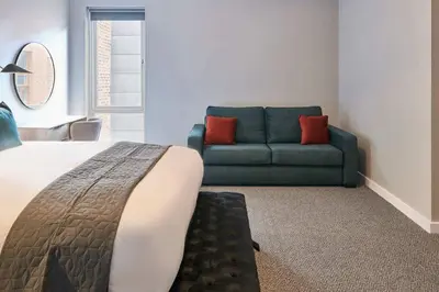a bedroom with a bed and a couch in a room at Ropewalks Retreat III - Sleeping 8 Guests with Parking in Liverpool